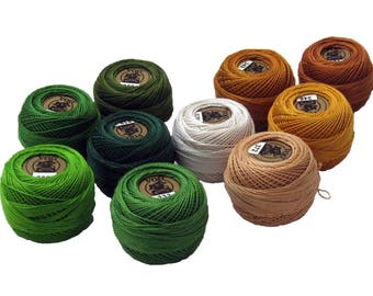 May include: A collection of ten spools of embroidery floss in various colors, including shades of green, brown, and white. Each spool has a label with text. Ideal for embroidery and other craft projects.