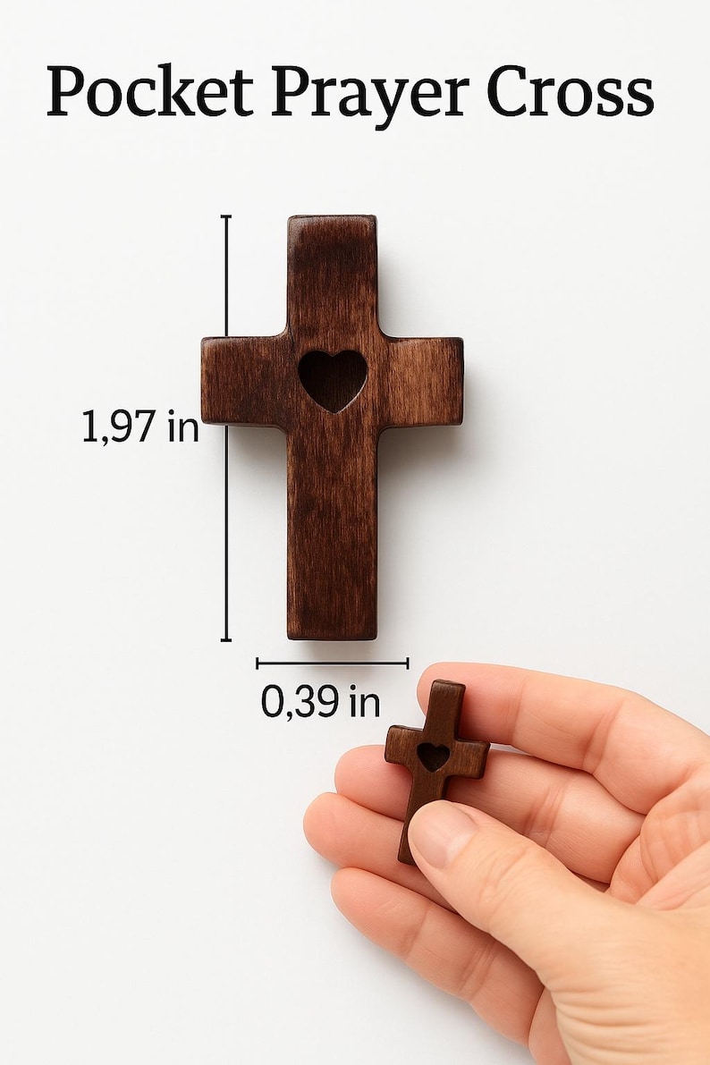 May include: A dark brown wooden pocket prayer cross with a heart-shaped cutout. The cross is 1.97 inches tall and 0.39 inches wide. The text "Pocket Prayer Cross" is at the top of the image.