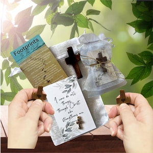 May include: An assortment of religious items, including wooden crosses, a small gold cross, and cards with inspirational text. One card reads "Footprints in the Sand," and another says "I can do all things through Christ who strengthens me."