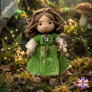 May include: A crocheted doll with brown yarn hair, wearing a green dress with white sleeves and embroidered white symbols. The doll features a small pendant at the neckline and holds a thin brown staff. The text pattern is visible in the corner.