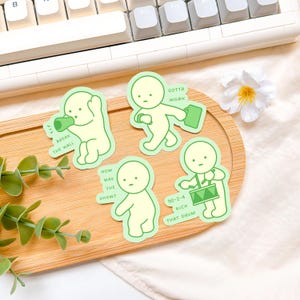 May include: Five green stickers featuring cartoon figures in various poses, each with a speech bubble. The text on the stickers reads: "Break the Wall", "Gotta Work", "How was the show?", and "90-2-4 Kick That Drum".