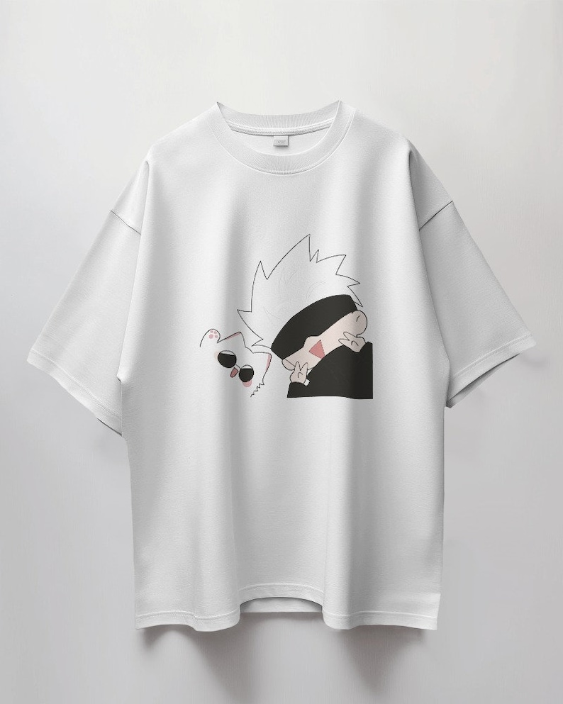 May include: White t-shirt with a black and white cartoon illustration of a character with spiky white hair wearing a black eye mask and a white cat with black sunglasses.