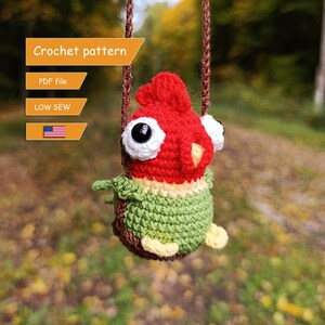 May include: A crochet pattern for a red and green bird on a swing. The pattern is available as a PDF file and is low sew. The pattern is available in English.