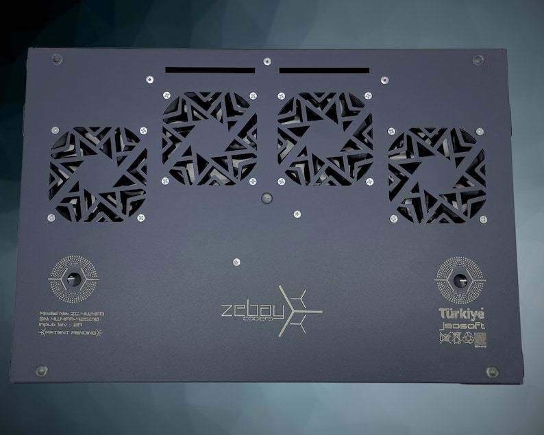 May include: A black metal box with three square cutouts featuring a geometric pattern. The box has the text "zebay cooler" and "T&uuml;rkiye Jeosoft" printed on it. The text "Model No: ZC-HLMNR SN: HLMR-H8570  Input: 12V - 3A  (PATENT PENDING)" is also printed on the box.