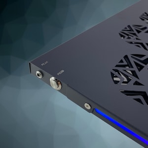 May include: A black metal computer case with a blue LED light strip along the bottom edge. The case has a cutout design on the side and features a power button and a USB port labeled "USB".