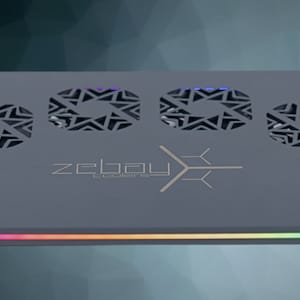 May include: A gray laptop cooling pad with three fans and a rainbow LED light strip. The pad has a black and gold logo that says "zebau" with the text "cyberware" underneath.