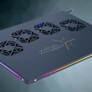 May include: A dark gray laptop cooling pad with three circular fan vents and a rainbow LED light strip along the edge. The pad has the text "zebau" in a silver font.