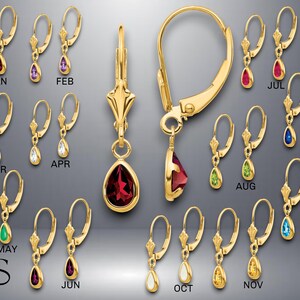 May include: A set of 12 pairs of gold dangle earrings with teardrop-shaped gemstones. Each pair features a different gemstone color representing a month of the year. The earrings are labeled with the months: January, February, March, April, May, June, July, August, September, October, November, and December.