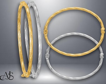 May include: Gold and silver bangles with intricate designs. The image shows several bangles, some in gold and others in silver. The bangles have detailed patterns and are displayed against a gradient gray background. The bangles are a jewelry item.
