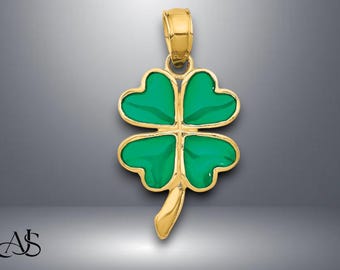 May include: A gold four-leaf clover pendant with green enamel.