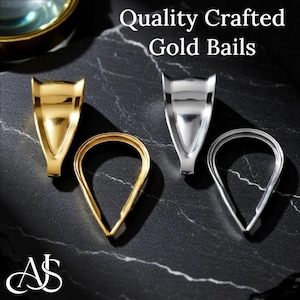 May include: Two gold-toned and two silver-toned metal jewelry bails. The set includes two triangular-shaped bails and two teardrop-shaped bails. The text Quality Crafted Gold Bails is visible at the top, and the logo AS is at the bottom.