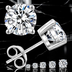 May include: A set of silver stud earrings with clear cubic zirconia stones. The earrings come in five different sizes.
