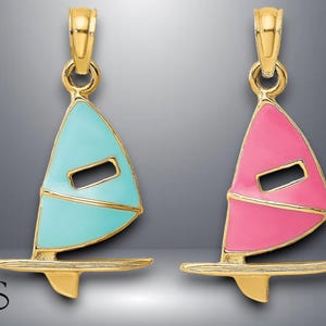 May include: Two gold-tone pendants shaped like sailboats. One pendant is blue and the other is pink.