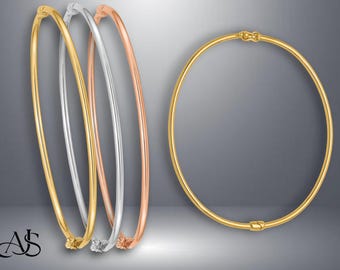 May include: Three gold bangle bracelets, one silver bangle bracelet, and one gold bangle bracelet with a hinge closure.
