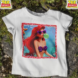 May include: A white ceramic mug with a black handle and the text "But First, Coffee" in a bold, black font. The mug is set against a neutral background, highlighting its simple design.