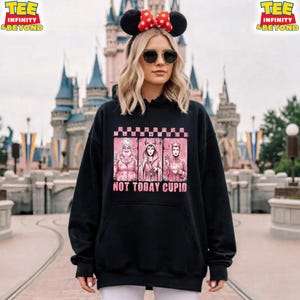 May include: Black hooded sweatshirt featuring a graphic of three cartoon villains in pink, with the text "NOT TODAY CUPID." The sweatshirt has a pink and white checkered pattern at the top of the graphic.