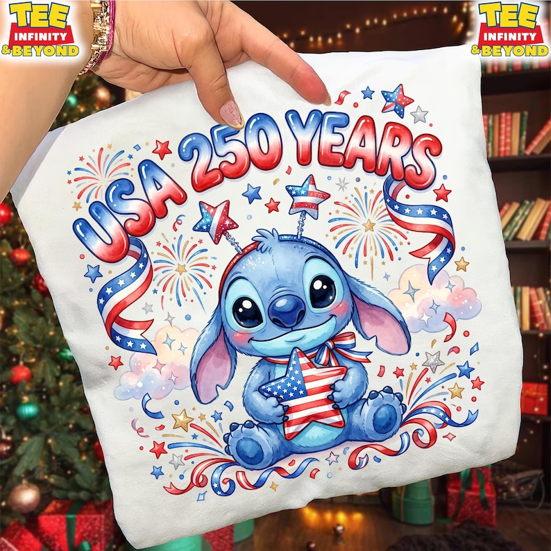 May include: White t-shirt featuring a cartoon character holding a star with the American flag design. The shirt has the text "USA 250 YEARS" in red, white, and blue, with fireworks and star accents. The design celebrates the USA.