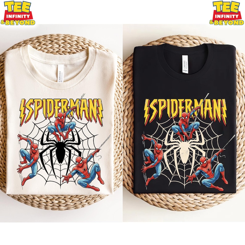 May include: Two t-shirts, one cream and one black, each featuring a Spider-Man graphic. The design includes the word "SPIDERMAN" in yellow lightning bolt lettering, Spider-Man figures, and a spiderweb.