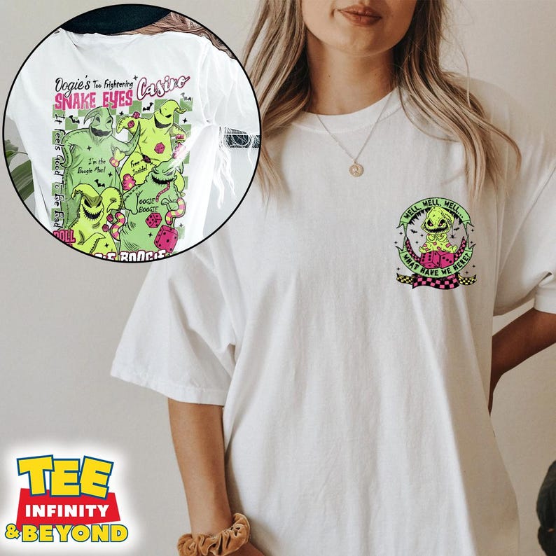 May include: White t-shirt featuring a graphic of Oogie Boogie from The Nightmare Before Christmas. The front design includes text "Oogie's Too Frightening Snake Eyes Casino" and "It Feels Good To Be Bad". A smaller design is on the back.