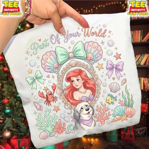 May include: White pillowcase featuring a colorful illustration of Ariel from The Little Mermaid, surrounded by seashells, bows, and sea creatures. The text "Part Of Your World" is written across the top. A dog is also featured in the design.
