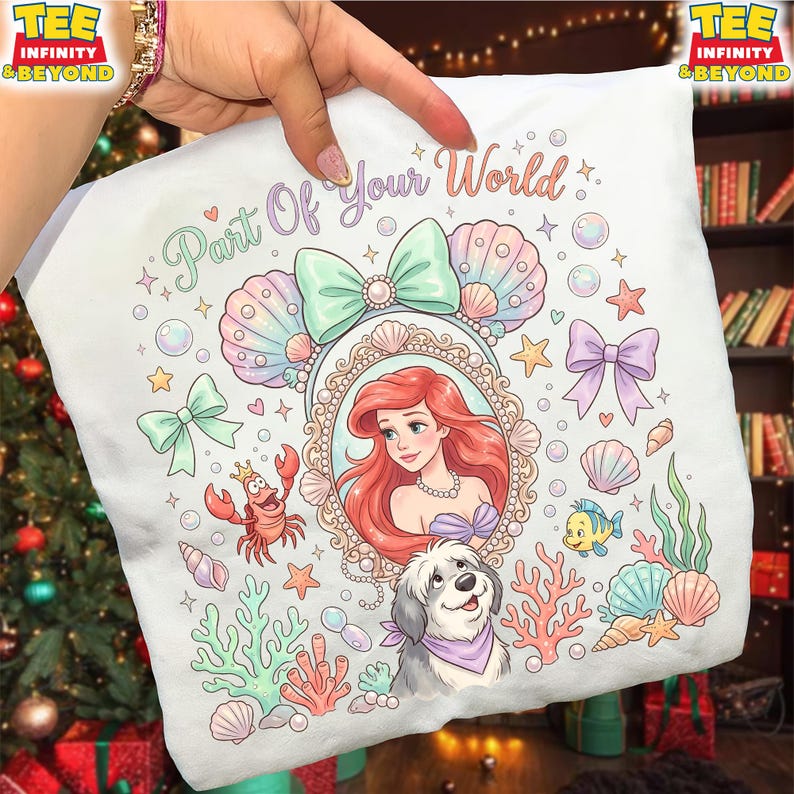 May include: White pillowcase featuring a colorful illustration of Ariel from The Little Mermaid, surrounded by seashells, bows, and sea creatures. The text "Part Of Your World" is written across the top. A dog is also featured in the design.