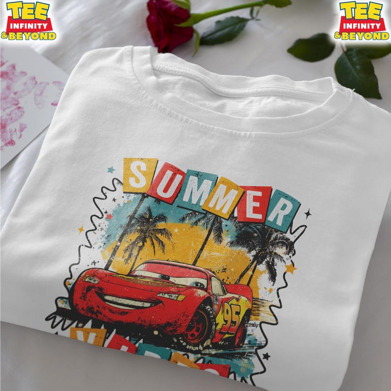 May include: White t-shirt featuring a graphic of Lightning McQueen from the movie Cars, with the word "SUMMER" above the car. The design includes palm trees and a colorful background. The shirt has the text "TEE INFINITY & BEYOND" on the top left and right.