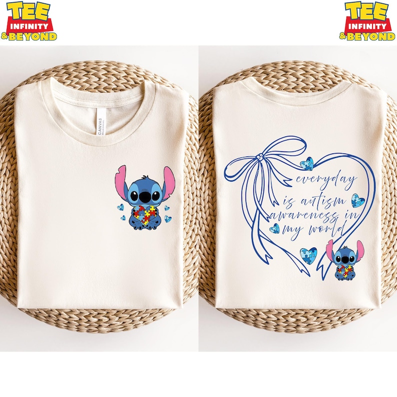 May include: Two cream-colored t-shirts. One features a blue cartoon character holding a puzzle piece, with blue puzzle pieces. The other shirt has a blue heart-shaped design with the text "everyday is autism awareness in my world."