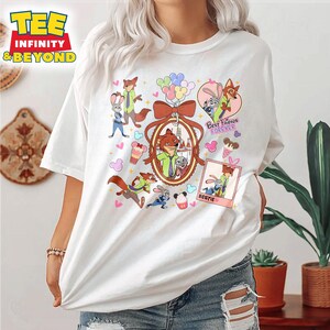 Puede incluir: Camiseta blanca con una ilustraci&oacute;n de dibujos animados de personajes de la pel&iacute;cula Zootopia. Los personajes son Nick Wilde y Judy Hopps. La camiseta tiene el texto "Best Friends Forever" y "Bestie".