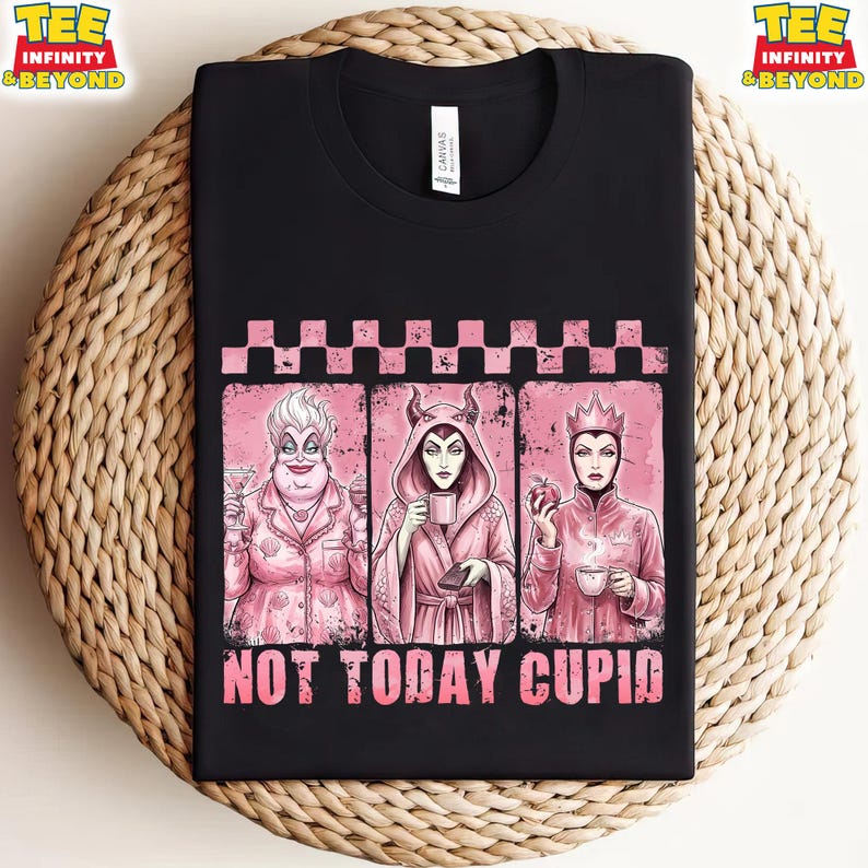 May include: Black t-shirt featuring three pink-toned illustrations of Disney villains. The illustrations are framed by a pink checkered border. The text "NOT TODAY CUPID" is printed in pink below the illustrations. The shirt has a crew neck.