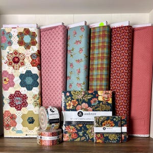 May include: A collection of fabric rolls and pre-cut fabric bundles in various patterns and colors. The rolls include floral, plaid, and geometric designs. The pre-cut bundles feature floral patterns and are labeled "Farmer's Daughter by Laundry Basket Quilts."