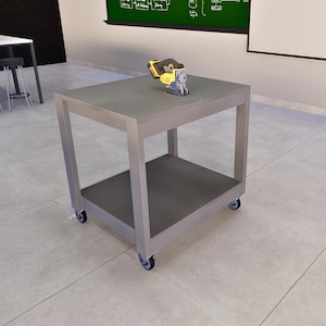 May include: A gray metal rolling workbench with two shelves. A yellow and black power tool is on the top shelf.