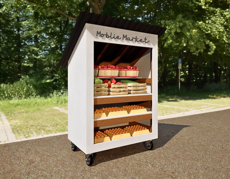 May include: A white wooden mobile market stand with a black roof and the words "Mobile Market" written on the front. The stand has shelves stocked with fresh produce, including red apples, green onions, and brown eggs.