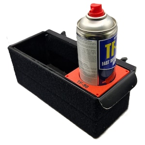 May include: A black storage container with a red insert for holding a can of TF-90 Fast Drying Spray. The container has a black felt lining.