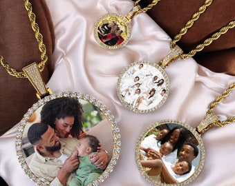 May include: Three gold chains with round pendants featuring photos of families. Each pendant is surrounded by a circle of clear stones.