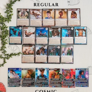 May include: A collection of fantasy trading cards, featuring various characters and scenes. The cards are labeled "REGULAR" and "COSMIC Holographic". Each card has unique artwork and text, with titles like "Monster Cave" and "Gaius & Inha".