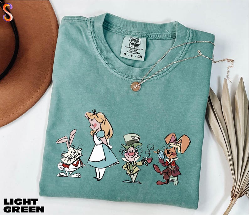 a t - shirt with a picture of alice and the seven dwarfs on it
