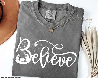 Christmas Believe Shirt, Christian Sweatshirt, Christmas Gift, Faith Sweater, Bible Verse Tee, Believe Comfort Colors T-Shirt