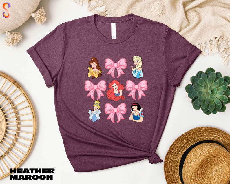a women's t - shirt with disney princesses on it