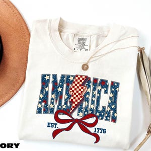 1776 America Shirt, 4th of July Coquette Bow Tee, Stars and Stripes T-Shirt, Independence Day Gift, USA Flag Sweater, Comfort Colors T-Shirt