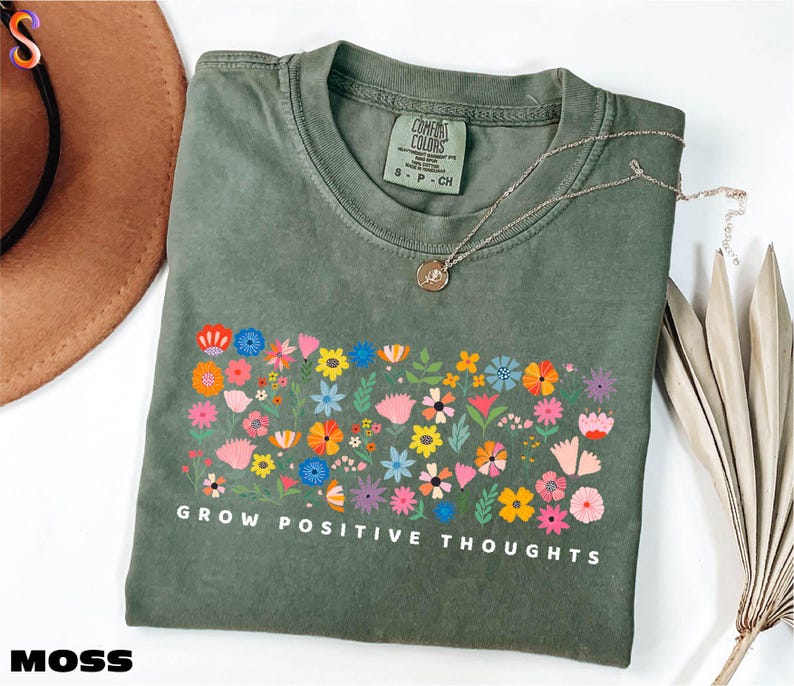 a t - shirt that says grow positive thoughts on it