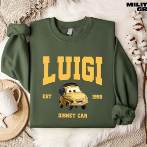 a green sweatshirt with a yellow car on it
