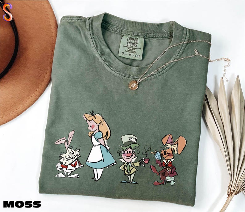 a t - shirt with a picture of alice and the seven dwarfs on it