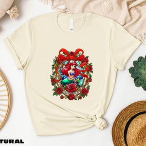 a t - shirt with a picture of a mermaid on it