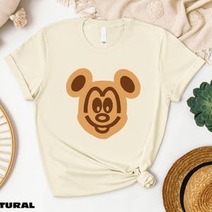 a t - shirt with a bear face drawn on it