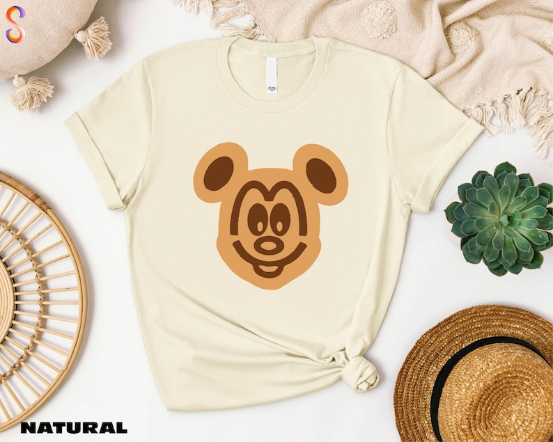 a t - shirt with a bear face drawn on it