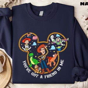 A navy blue sweatshirt with a cartoon character design featuring characters from the Toy Story franchise, including Woody, Buzz Lightyear, and other beloved characters.
