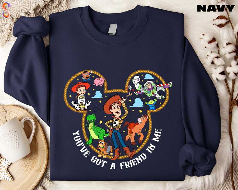 A navy blue sweatshirt with a cartoon character design featuring characters from the Toy Story franchise, including Woody, Buzz Lightyear, and other beloved characters.
