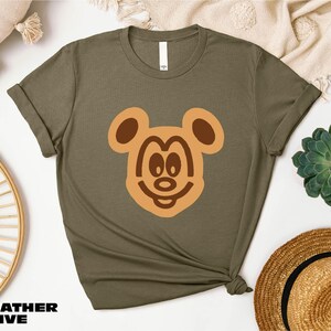a t - shirt with a bear face drawn on it