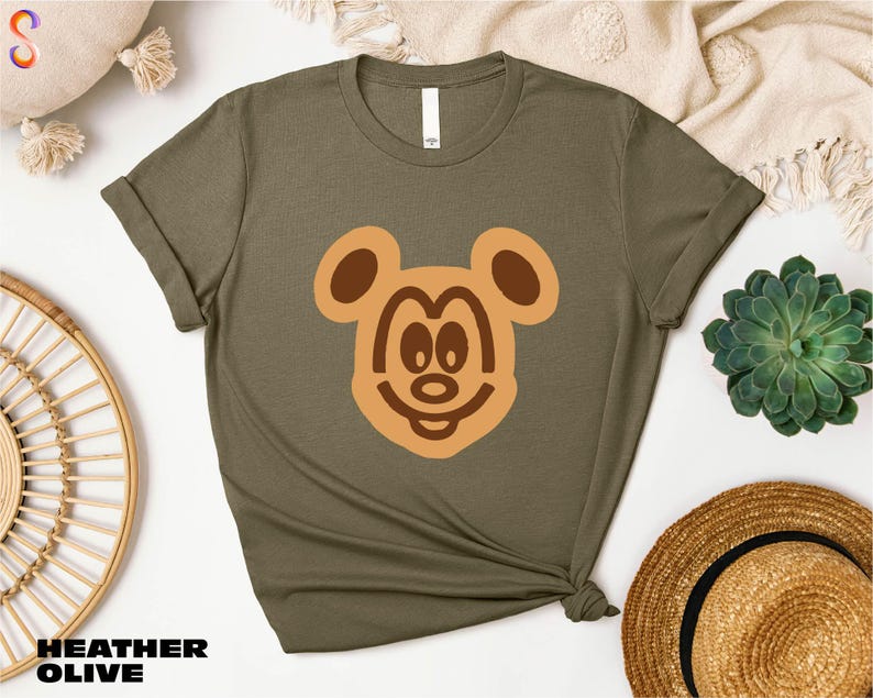 a t - shirt with a bear face drawn on it