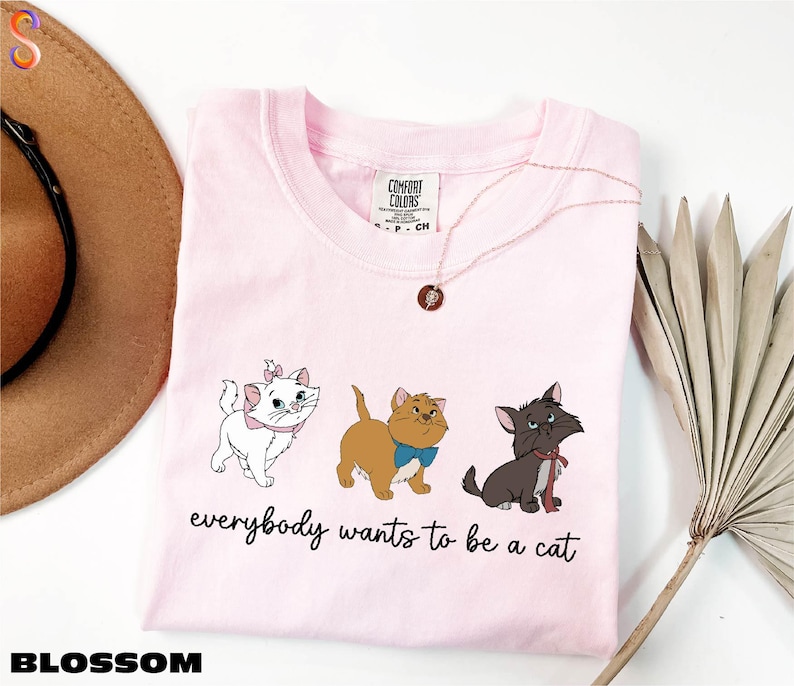 a pink shirt with three dogs on it